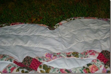 Quilt spread out on the grass
