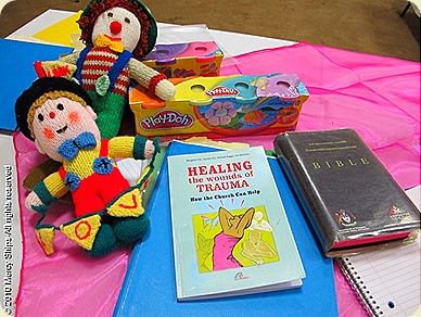 donors items-dolls made by womens church group in UK, Play dough-donated by Hasbro toy Co. Healing the wounds of Trauma teaching materials.