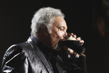 Tom Jones drinks a pint of Guinness at the Arthurs Day celebrations in the Guinness Storehouse