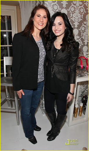 BEVERLY HILLS, CA - JANUARY 16: Senior vice president of marketing for L'Oreal Anne Talley (L) and actress Demi Lovato pose with the L'Oreal display during the HBO Luxury Lounge in honor of the 67th annual Golden Globe Awards held at the Four Seasons Hotel on January 16, 2010 in Beverly Hills, California. (Photo by Angela Weiss/Getty Images for mediaplacement)