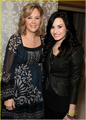 BEVERLY HILLS, CA - JANUARY 16: L'Oreal Powers/Public relations Kristin Holmes (L) and actress Demi Lovato pose with the L'Oreal display during the HBO Luxury Lounge in honor of the 67th annual Golden Globe Awards held at the Four Seasons Hotel on January 16, 2010 in Beverly Hills, California. (Photo by Angela Weiss/Getty Images for mediaplacement)