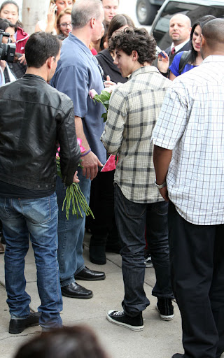 02-02-10 Sherman Oaks, CA  Nick Jonas performed a solo show for his fans outside of Mark's Garden flower shop in Sherman Oaks. After the show, he handed out roses to all the girls in attendance. Like a typical teenager, Nick has a few zits on his face.  NON-EXCLUSIVE PIX by Flynet ©2010 818-307-4813  Nicolas