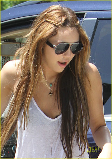 Miley Cyrus, in her short shorts and string tank, out with a friend. They smile for the cameras. April 25, 2010 X17online.com exclusvie