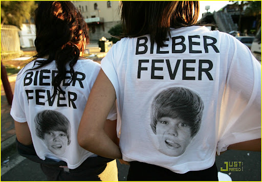SYDNEY, AUSTRALIA - APRIL 26: Justin Bieber fans show their support at Circular Quay on April 26, 2010 in Sydney, Australia. Bieber had been scheduled to perform an outdoor concert in front of the Overseas Passenger Terminal at Circular Quay. However after around 5000 people camped out overnight for the performance, police were forced to cancel the outdoor show after several young fans were crushed during crowd surges. Bieber went ahead and performed at the Seven networks headquarters at Martin Place instead. (Photo by Graham Denholm/Getty Images)