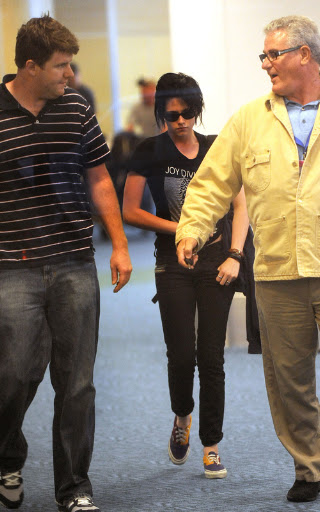 Kristen Stewart punches the air as she arrives back in Vancouver for Twilight. The Twilight star who plays Bella Swan in the hit series arrived back after catching an early flight from LA. Kristen who was at the Teen Choice Awards arrived back for the third installment 'Eclipse' <P> Pictured: Kristen Stewart <B>Ref: SPL118680 100809 </B><BR/> Picture by: Whittle/Beetham /Randy/ Splash<BR/> </P><P> <B>Splash News and Pictures</B><BR/> Los Angeles: 310-821-2666<BR/> New York: 212-619-2666<BR/> London: 870-934-2666<BR/> photodesk@splashnews.com<BR/> </P>