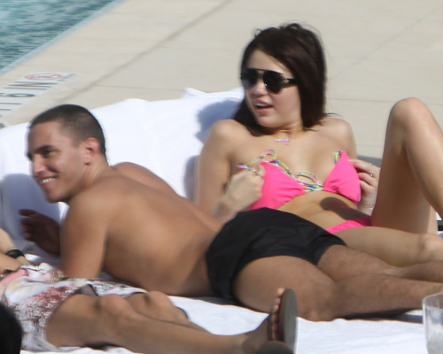December 3, 2009: Miley Cyrus pictured sunbathing by the pool in Miami, Florida. Credit: INFphoto.com Ref.: infusmi-11/13