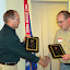 FAA Safety Team Program Manager Chris Manthe presents Shane Vande Voort with two flight awards (photo courtesy Classic Aviation)