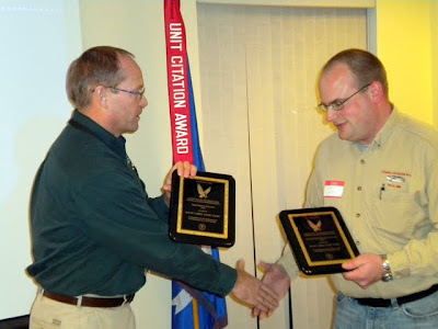 FAA Safety Team Program Manager Chris Manthe presents Shane Vande Voort with two flight awards (photo courtesy Classic Aviation)