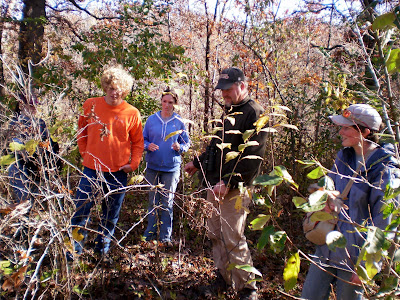 Professor Russ Benedict of Central College discusses vegetation managment plan with students at Hickory Ridge