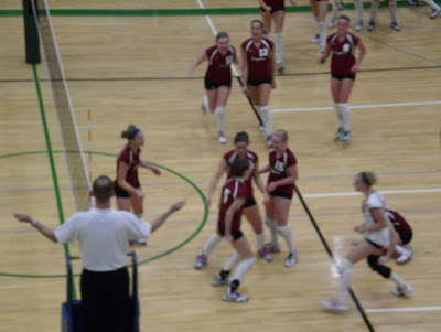 Pella Christian players gather to celebrate after match point of the Regional Semifinal against Clarke