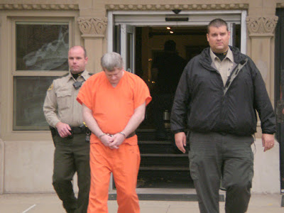 Deputy Brian Bigaouette and Jailer Scott Jerkins lead Steven Dean McGinnis from courthouse after sentencing.