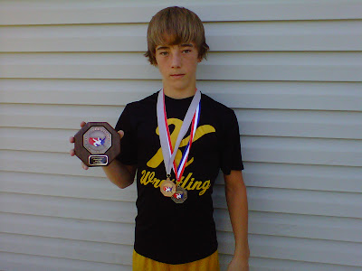 Knoxville Wrestler Jay Fresh with medals he has won this summer.