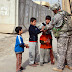 CPT_Carbone_gives_candy.jpg, BAGHDAD - Capt. Chris Carbone, a North Haledon, NJ, native, and the civil affairs team leader and platoon leader for the Enabler Platoon, Headquarters and Headquarters Company, 1st Battalion, 505th Parachute Infantry Regiment, attached to 1st Brigade Combat Team, 4th Infantry Division, Multi-National Division - Baghdad, gives candy to local Iraqi children during a dismounted patrol., 2009-01-29 CPT Chris Carbone