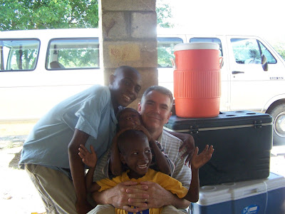 Mr Mike takes time from all the measuring and weighing for hugging and laughing