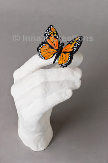 Quilled butterfly with plaster cast hand