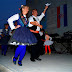 People wearing traditional costumes are dancing Susak dances