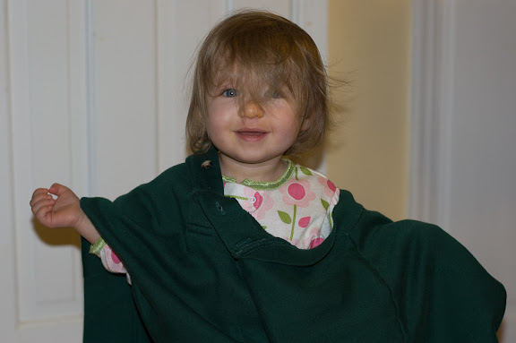Wearing one of daddy's sweaters.