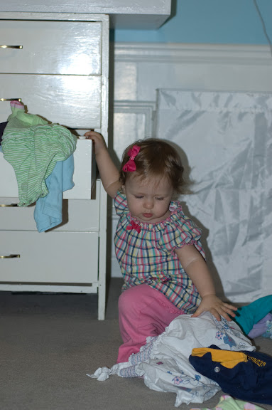 She also loves 'helping' mommy by emptying and then refilling drawers and any other containers.