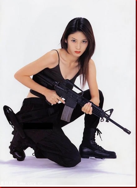 serious girl with gun