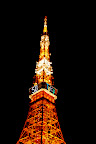 Tokyo Tower full aglow stretching up into the night.