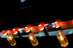 Pairing the candles with the lights of a restaurant boat.
