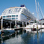 Whisper dwarfed by tour boat in Bell Harbor Marina