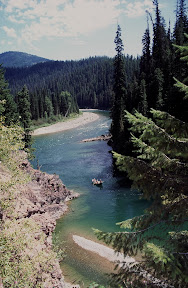America The Beautiful - A drift boat slips quietly down the North Fork of the Flathead River in Northwest Montana. The North Fork travels through some of Montana's most spectacular scenery, including the western perimeter of Glacier National Park. The fishing is good, though not nearly as good as the Flathead's South Fork, which travels out of the Bob Marshall Wilderness. Still, the North Fork is well worth a day-long float. Be sure to bring your camera.