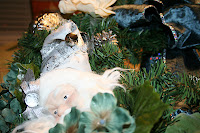 Christmas Wreath: I found the 60 - 70% cast-offs @ Michael's and came up with this lovely piece, mixing the blues, whites, and tarnished silvers into a fun wreath for the front door.