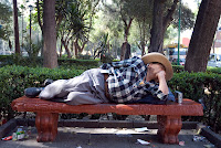 Sleeping on a park bench in Mexico City. You can almost see the radio that was playing all the time.