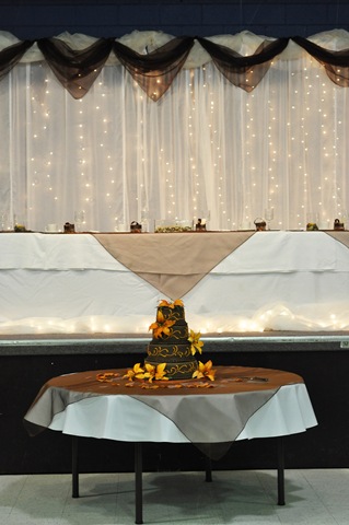 The cake table and head table with the brown organza squares