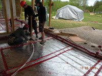 Kaily, Kate and Brad lay out the piping, using the width of a tamper as their guide while stapling every 3 feet or so.
MVG