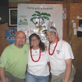 Don, Kat and Brian doing the pose and smile for a pic yall thing in front of the club banner.