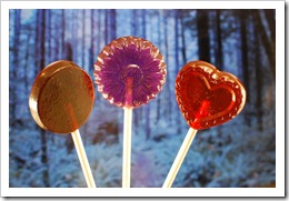 red, purple and brown lollipops with black sticks