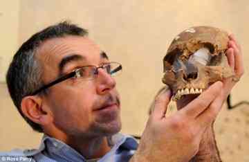 The skull of the gladiator found during the refurbishment of the Yorkshire Museum being held by its curator Andrew Morrison. He was very tall for a Roman, standing at 5ft 10in, and of muscular build. The average height for people living at that time was 5ft 3in.