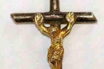 The silver and gold medieval crucifix found in a field at Winterborne Muston.