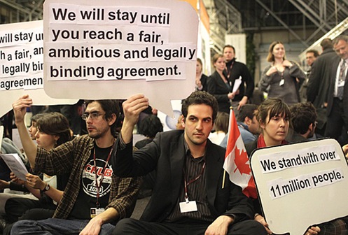Activists hold up a banners demanding a legally binding agreement in Copenhagen.