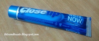 close up white now toothpaste tube, by bitsandtreats