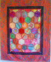 HEIRLOOM HEXAGON QUILT - 175cm x 144cm (69 in x 56 in) This is a reversible  quilt-as-you-go quilt. You can use scraps of many different types of fabric including silks, velvets and brocades on the front, then complementary fabrics on the reverse side. Beginner to advanced.