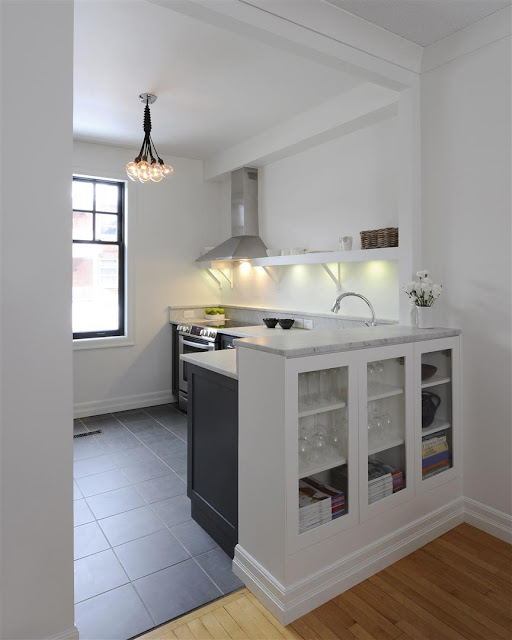 beautiful pale granite counter top, dark cabinets, contemporary lighting, light paint