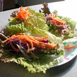 Red lettuce wraps filled with pate and topped with sprouted mung beans, purple cabbage, and shredded carrots