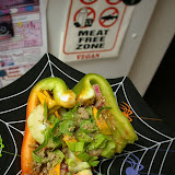 Half nommed bell pepper boat filled with nut/veggie pate, celery leaves, rainbow chard stems, cucumber, and marinated/dehydrated squash chunks