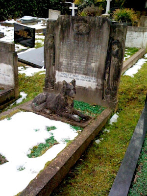 Tombstone with a dog on it in Highgate Cemetery in London