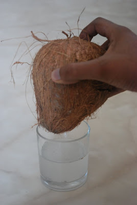 Draining the coconut juice
