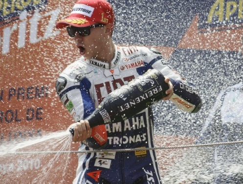 Yamaha MotoGP rider Jorge Lorenzo of Spain sprays champagne on the podium after his victory at the Catalunya's Grand Prix in Montmelo, near Barcelona, July 4, 2010. REUTERS/Curial Lupresti - Content © 2010 Reuters All rights reserved.