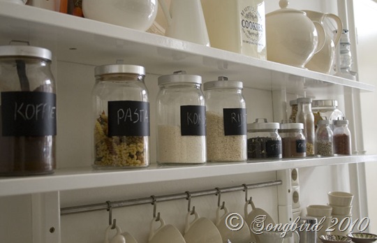 Kitchen shelf with glass labeled jars