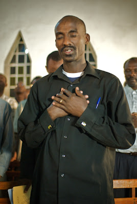 Man praying at chapel service