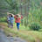 Women carrying poles on heads along road Women carrying poles on heads along road
