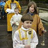 Nilus Swanson, 7, carries a candle while his brother John Swanson, 10, follows during a Theophany celebration Tuesday by St. Elizabeth Orthodox Mission in Poulsbo. Behind them are Nicholas Ferrenberg, 8, of Poulsbo and his father James Ferrenberg, a sub-deacon. St. Elizabeth Church the only Eastern Orthodox church in Kitsap County. The ceremony at the Oyster Plant Park dock in Poulsbo represented the baptism of Jesus. (LARRY STEAGALL | KITSAP SUN)