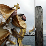 Father Christopher Swanson takes part in Theophany ceremonies Tuesday at Oyster Plant Park dock in Poulsbo. Swanson, of Suquamish, leads St. Elizabeth Orthodox Mission, the county's only Eastern Orthodox Church. The ceremony represented the baptism of Jesus. LARRY STEAGALL | KITSAP SUN