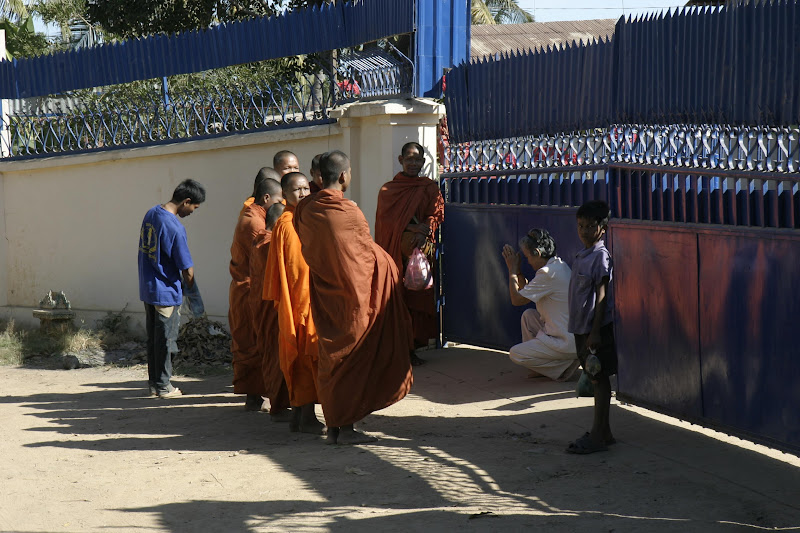 Monks begging for food and goods.